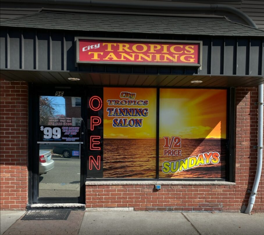 City Tropics Tanning salon storefront with window displays and promotions